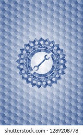 wrench icon inside blue emblem with geometric pattern background.