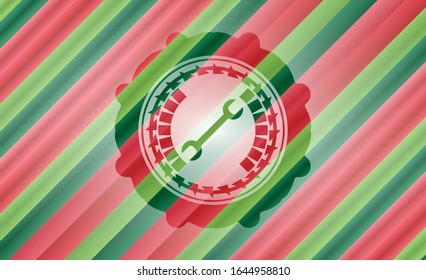 wrench icon inside christmas style badge..