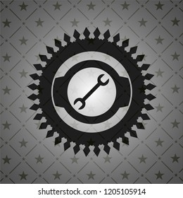 wrench icon inside dark badge