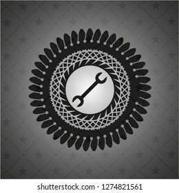 wrench icon inside dark badge or emblem