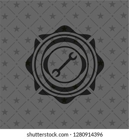 wrench icon inside dark badge