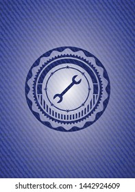 wrench icon inside denim background