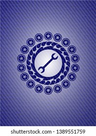 wrench icon inside emblem with jean texture