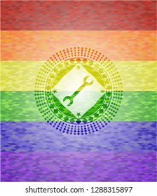 wrench icon inside emblem on mosaic background with the colors of the LGBT flag