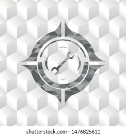 wrench icon inside grey badge with geometric cube white background