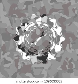 wrench icon inside grey camouflaged emblem