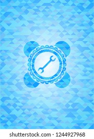 wrench icon inside realistic light blue mosaic emblem