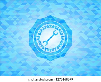 wrench icon inside realistic light blue emblem. Mosaic background