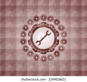wrench icon inside red seamless badge with geometric pattern.
