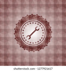 wrench icon inside red seamless badge with geometric background.