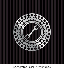 wrench icon inside silver emblem