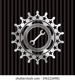 wrench icon inside silver shiny emblem. 