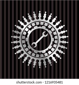 wrench icon inside silvery emblem