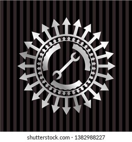 wrench icon inside silvery emblem