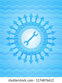 wrench icon inside sky blue water wave emblem.