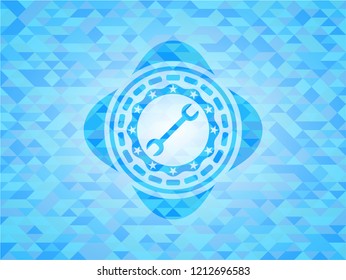 wrench icon inside sky blue emblem with triangle mosaic background