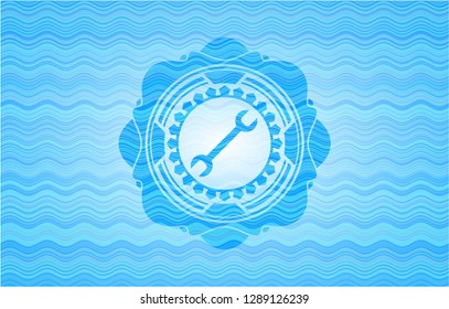 wrench icon inside sky blue water emblem.