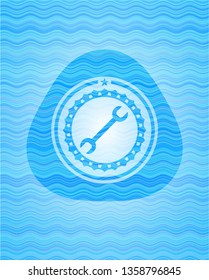 wrench icon inside water concept badge.