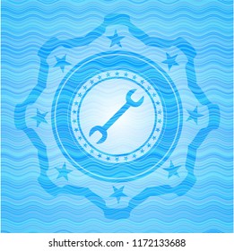 wrench icon inside water wave emblem.