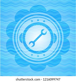 wrench icon inside water wave emblem.