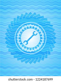 wrench icon inside water wave concept badge.
