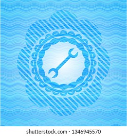 wrench icon inside water wave representation emblem.