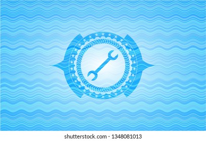 wrench icon inside water wave style badge.