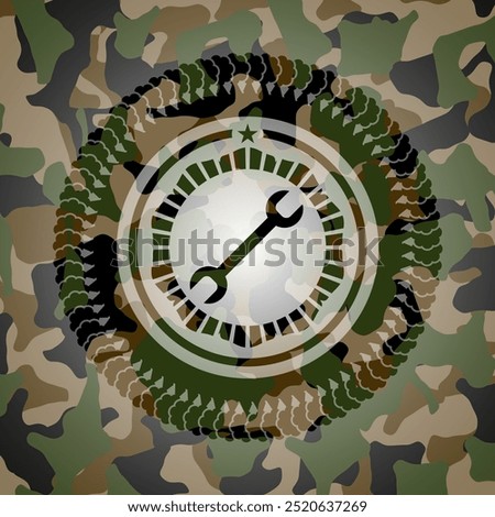 wrench icon on camo texture. 