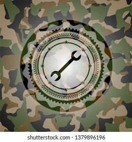 wrench icon on camouflage pattern