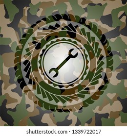 wrench icon on camouflaged pattern