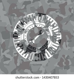 wrench icon on grey camouflage pattern