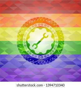 wrench icon on mosaic background with the colors of the LGBT flag