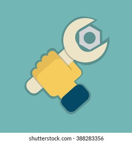 Wrench and nut in the hand of man.