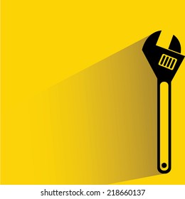 wrench on yellow background, flat and shadow theme