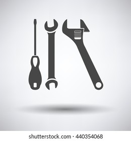Wrench and screwdriver icon on gray background, round shadow. Vector illustration.