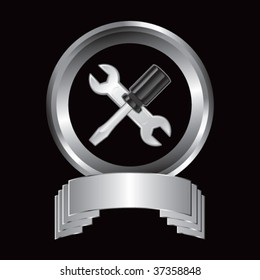 wrench and screwdriver on silver crest