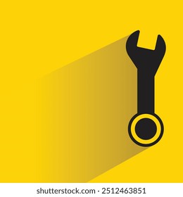ícone de ferramenta de chave inglesa com sombra no plano de fundo amarelo