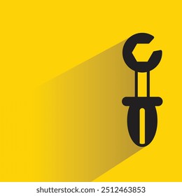 ícone de ferramenta de chave inglesa com sombra no plano de fundo amarelo