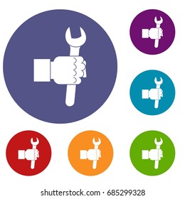 Wrench tool in man hand icons set