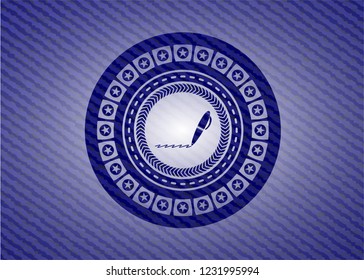 writer icon inside badge with denim texture