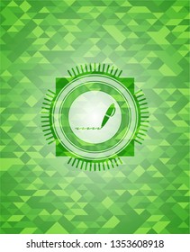 writer icon inside green emblem with triangle mosaic background