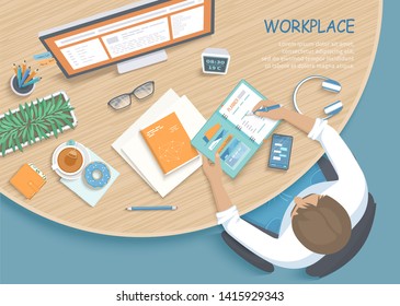 Мan writing notes in a planner at a round wooden desk. Workplace Desktop Workspace Office supplies, monitor, book, phone, glasses, pen, paper, tea, donut, purse. Vector Top view 