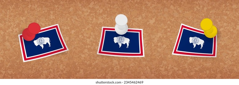 Wyoming flag pinned in cork board, three versions of Wyoming flag. Vector pushpins and flag set.