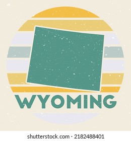 Wyoming logo. Sign with the map of us state and colored stripes, vector illustration. Can be used as insignia, logotype, label, sticker or badge of the Wyoming.
