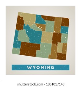 Wyoming map. US state poster with regions. Old grunge texture. Shape of Wyoming with US state name. Artistic vector illustration.