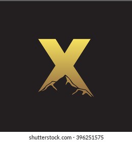 X alphabet mountain negative space letter logo gold black background