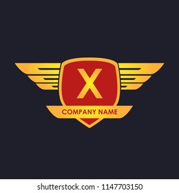 X initial shield with wings gold color logo