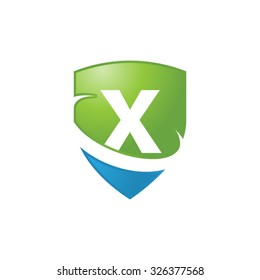 X initial swoosh shield logo blue green