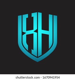 Monograma del logotipo XH con diseño de escudo de emblemas aislado con colores azules sobre fondo negro