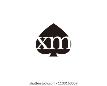 The xm initials logo inside the black shovel